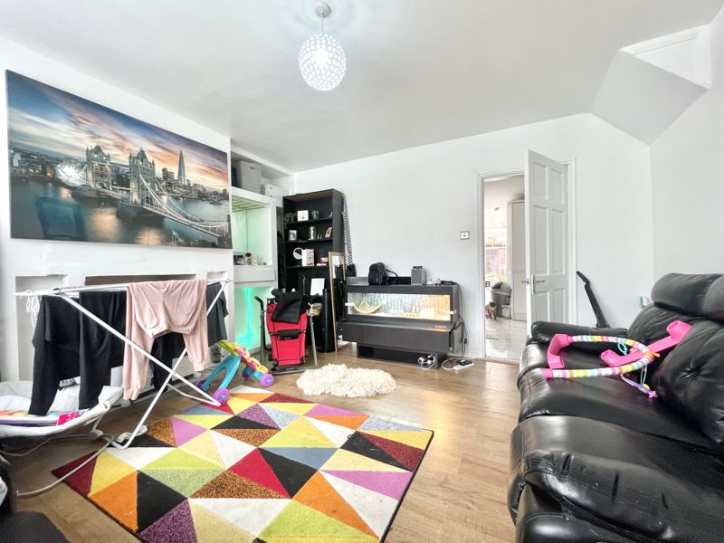 BEFORE: Living room with toys, personal photos, cluttered coffee table